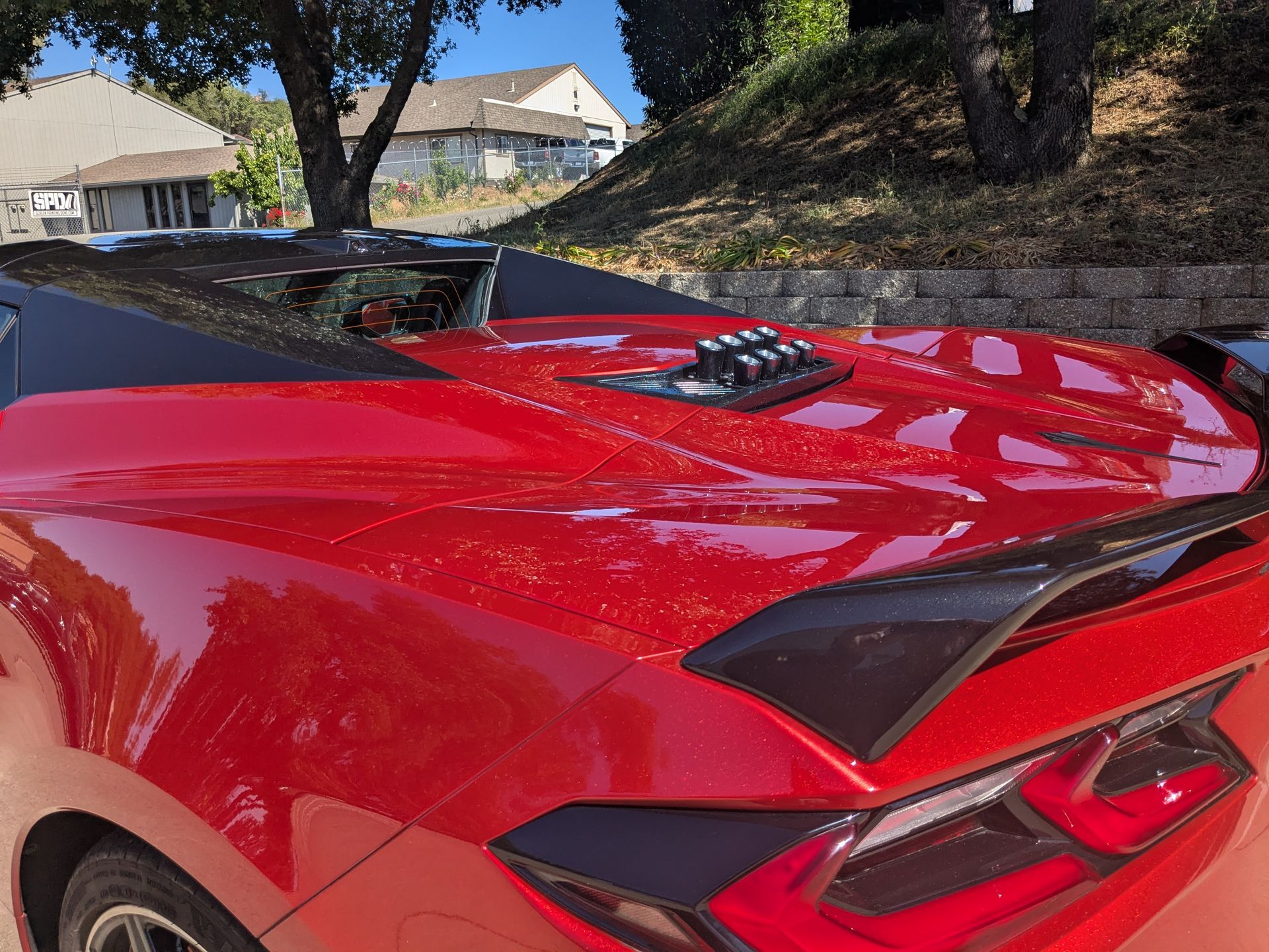 A red sports car is parked in front of a house