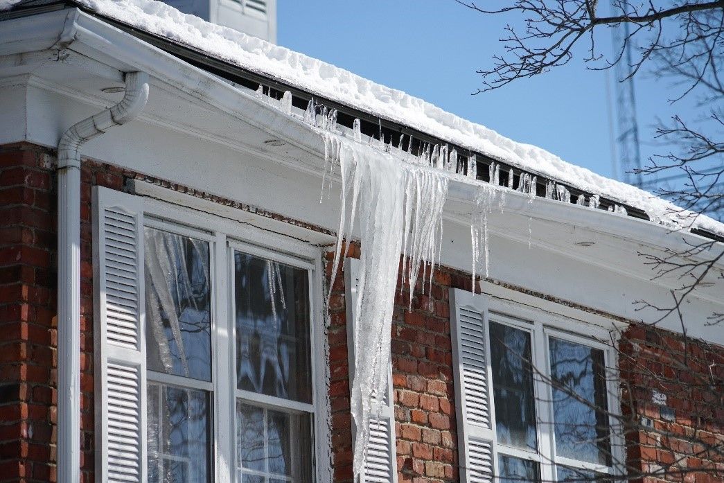 Large icicles hanging from a roof