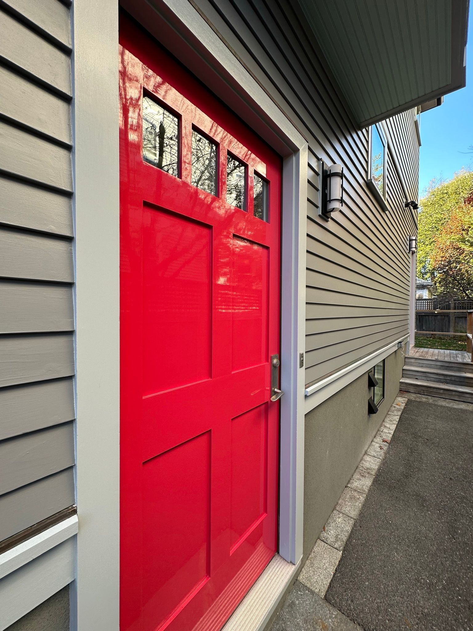 Red door with gray trim and siding.
