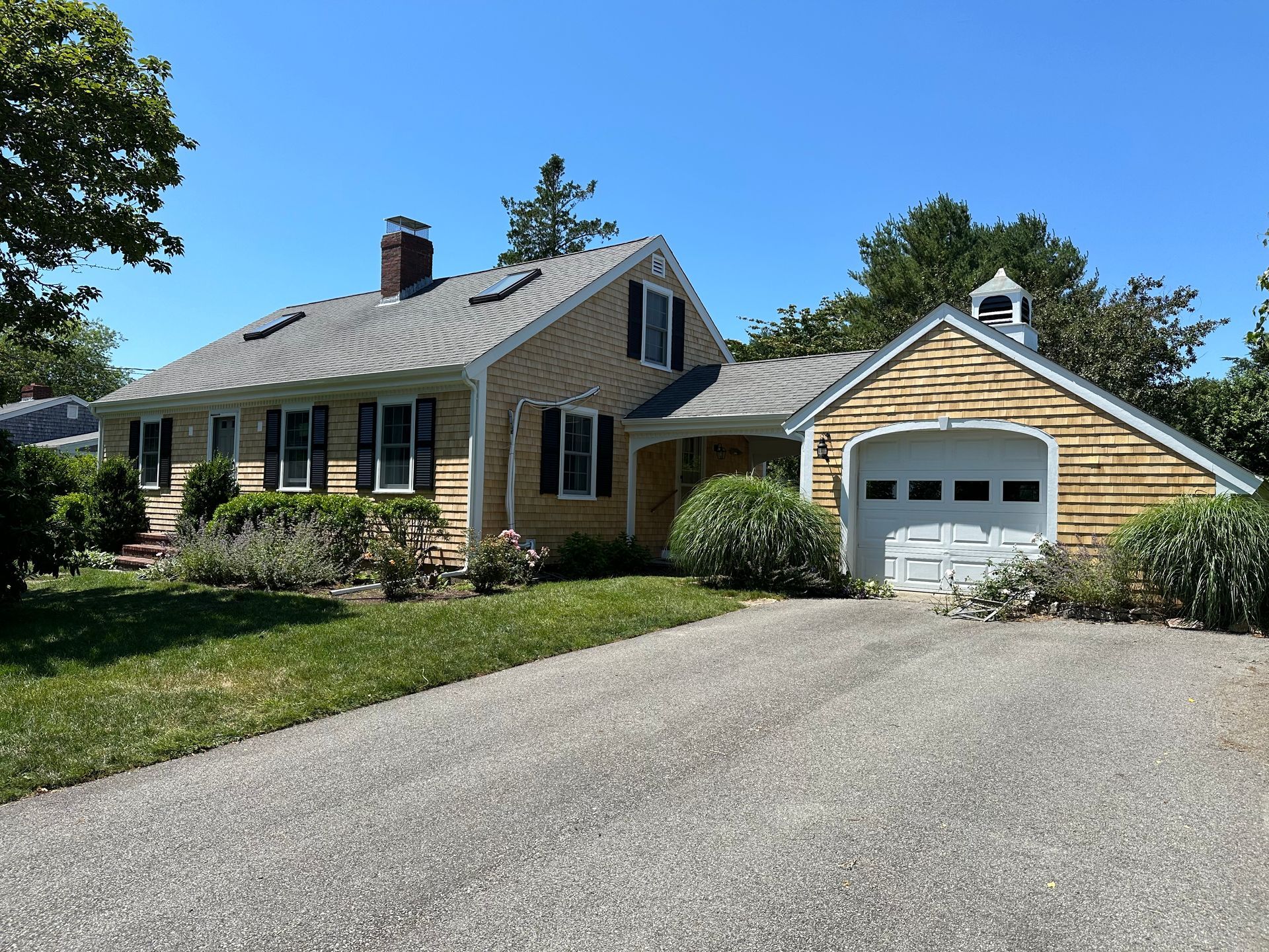 A house with a garage and a driveway in front of it