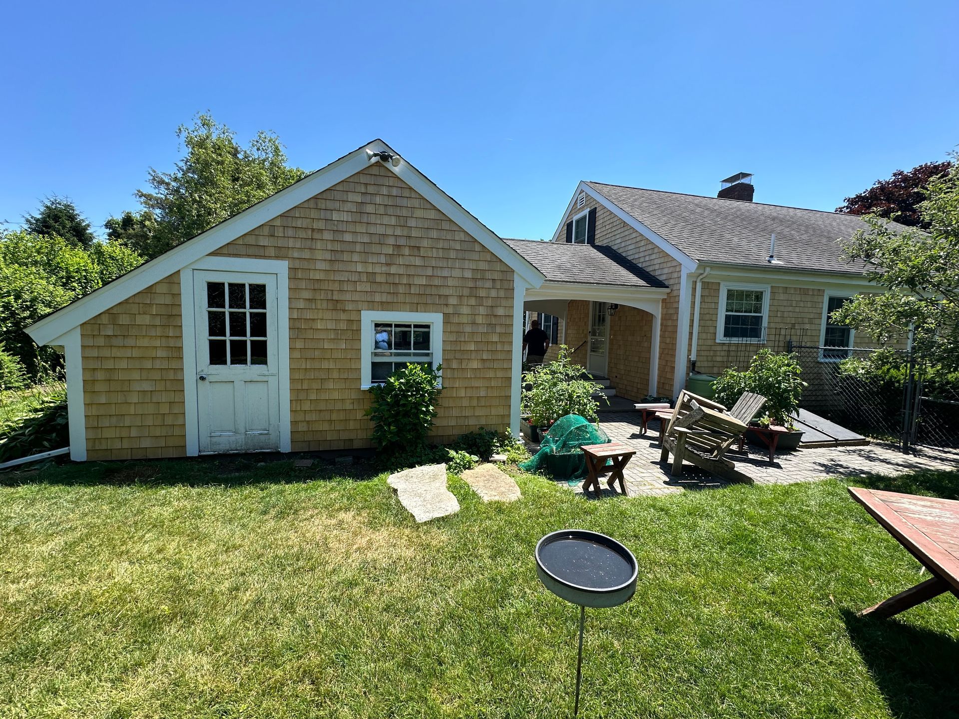 A small house with a shed in the backyard