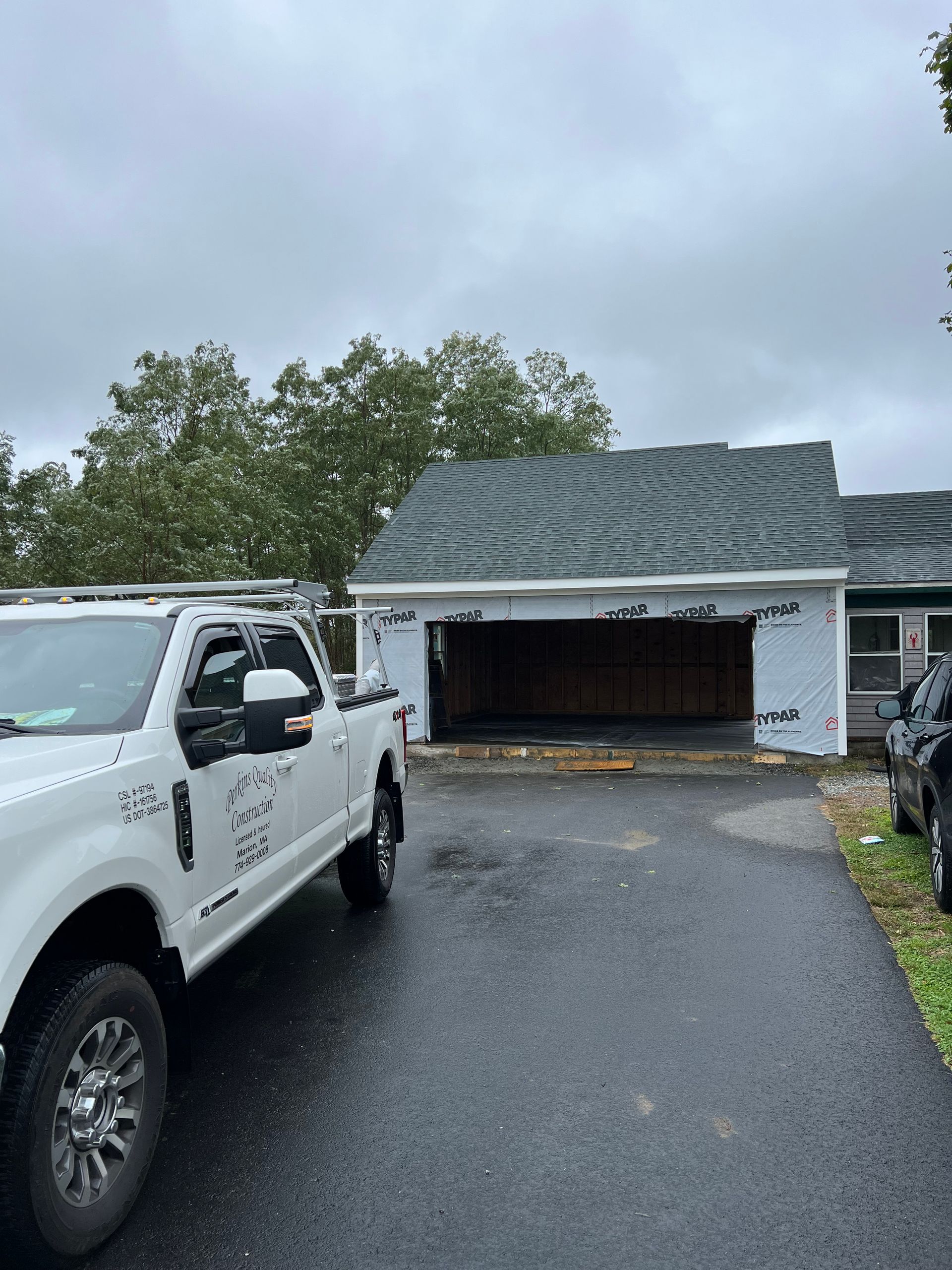 A white truck is parked in front of a house.
