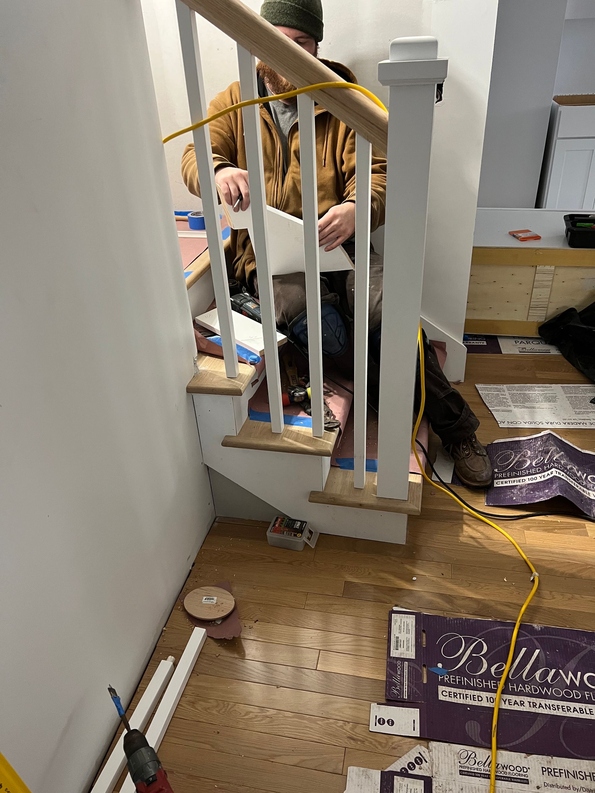 A man is sitting on the stairs looking at a piece of paper.