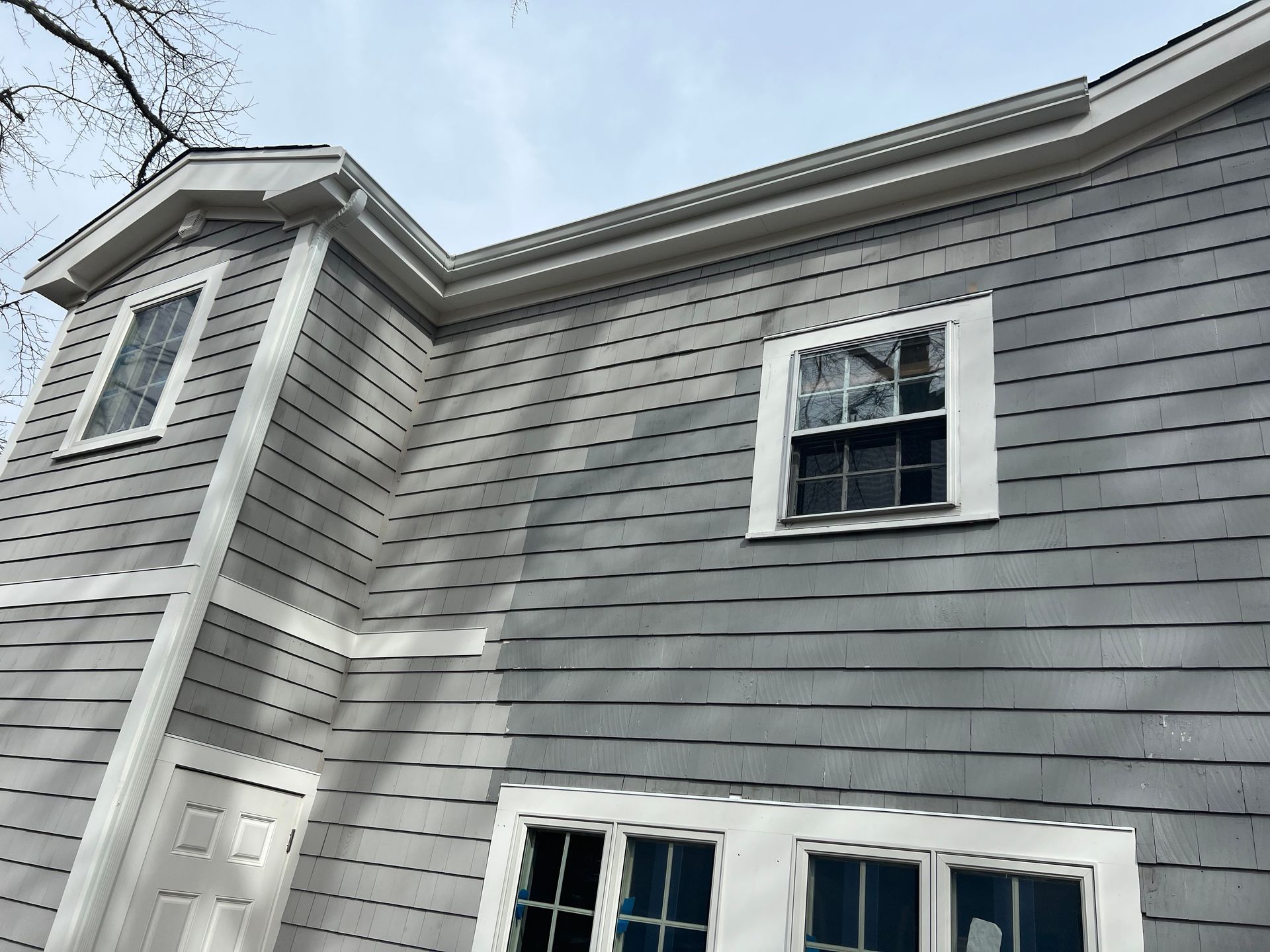 A house with a lot of windows on the side of it.