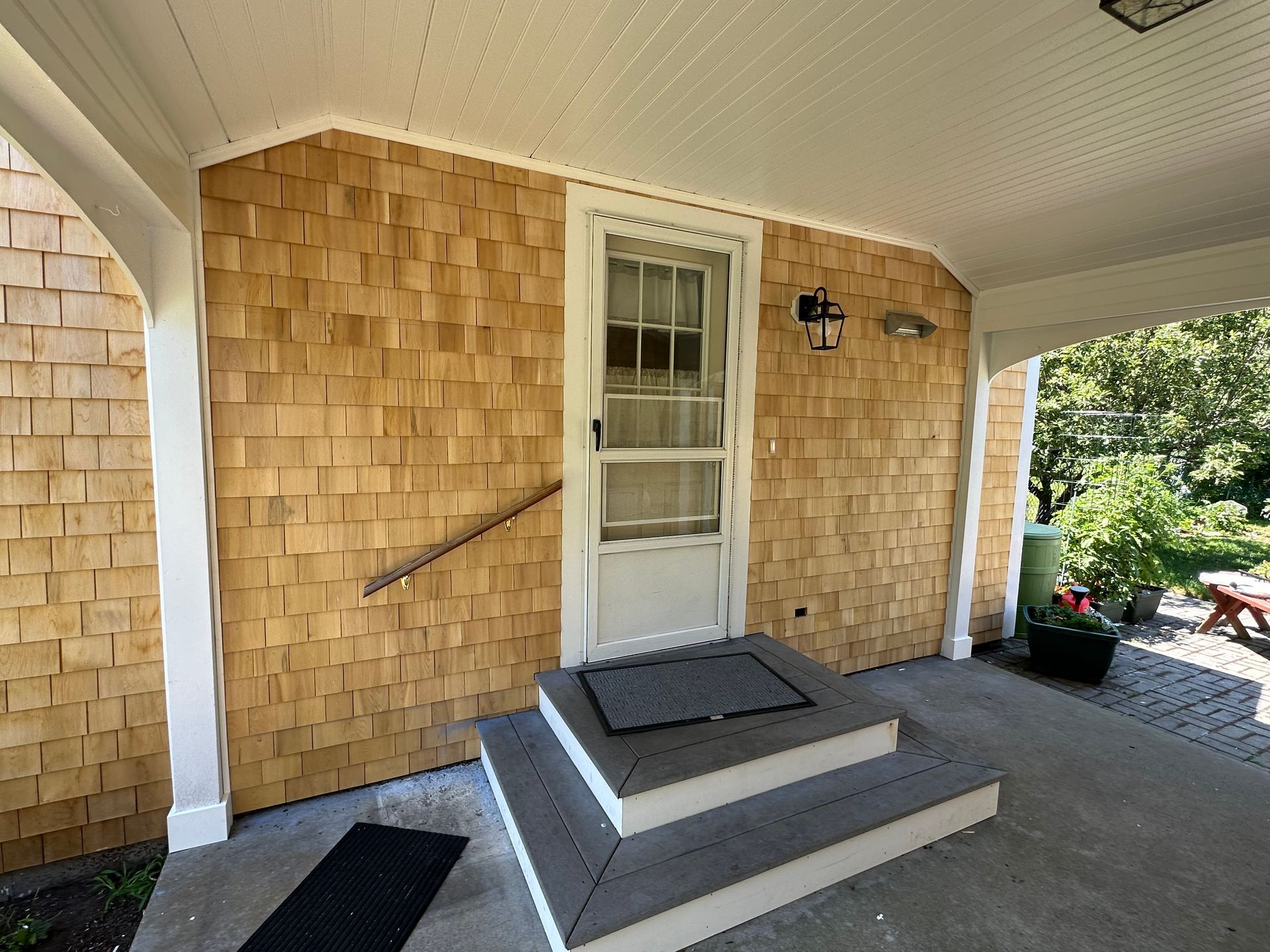 A porch with steps leading up to a door