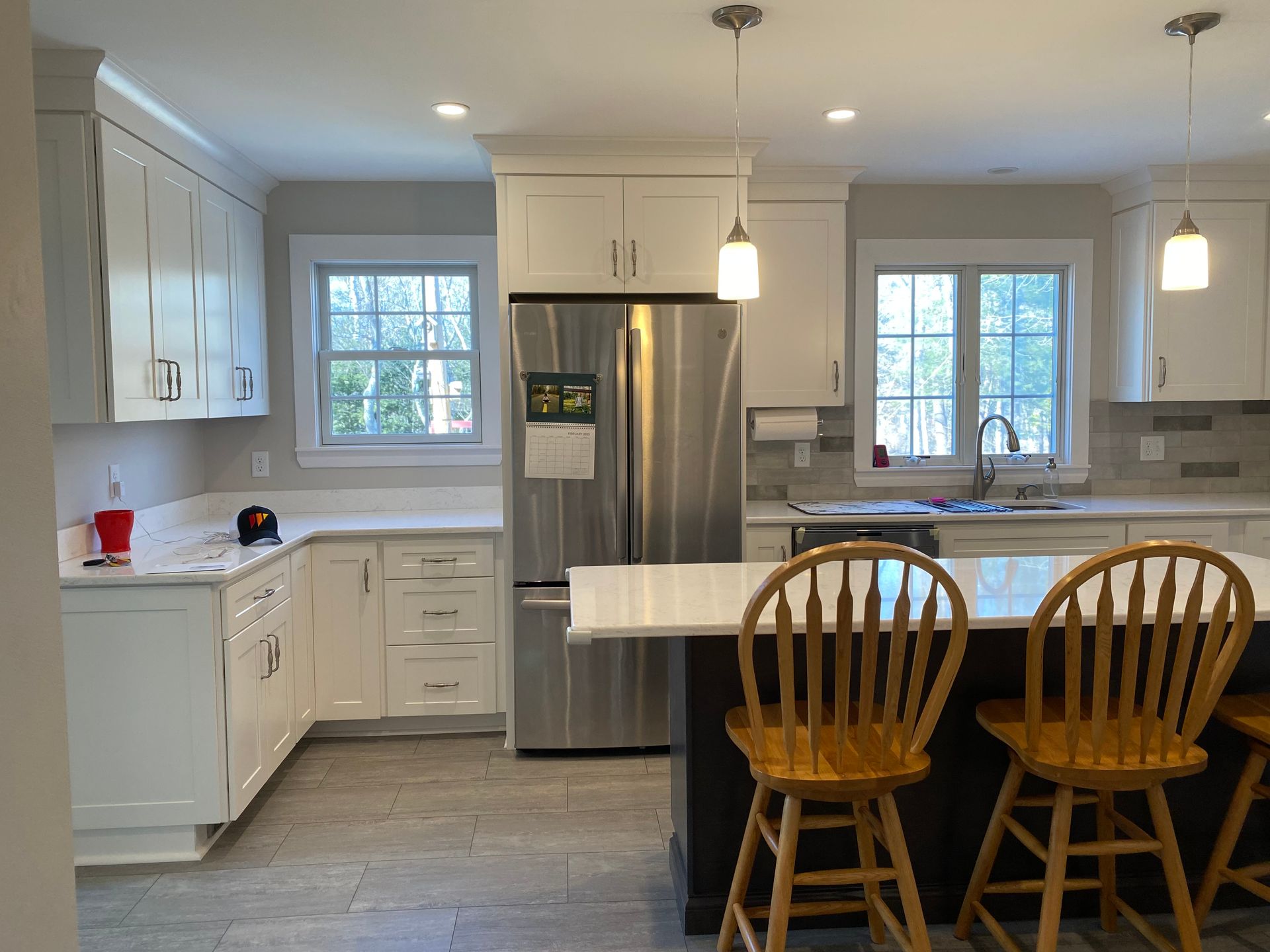 A kitchen with stainless steel appliances and white cabinets