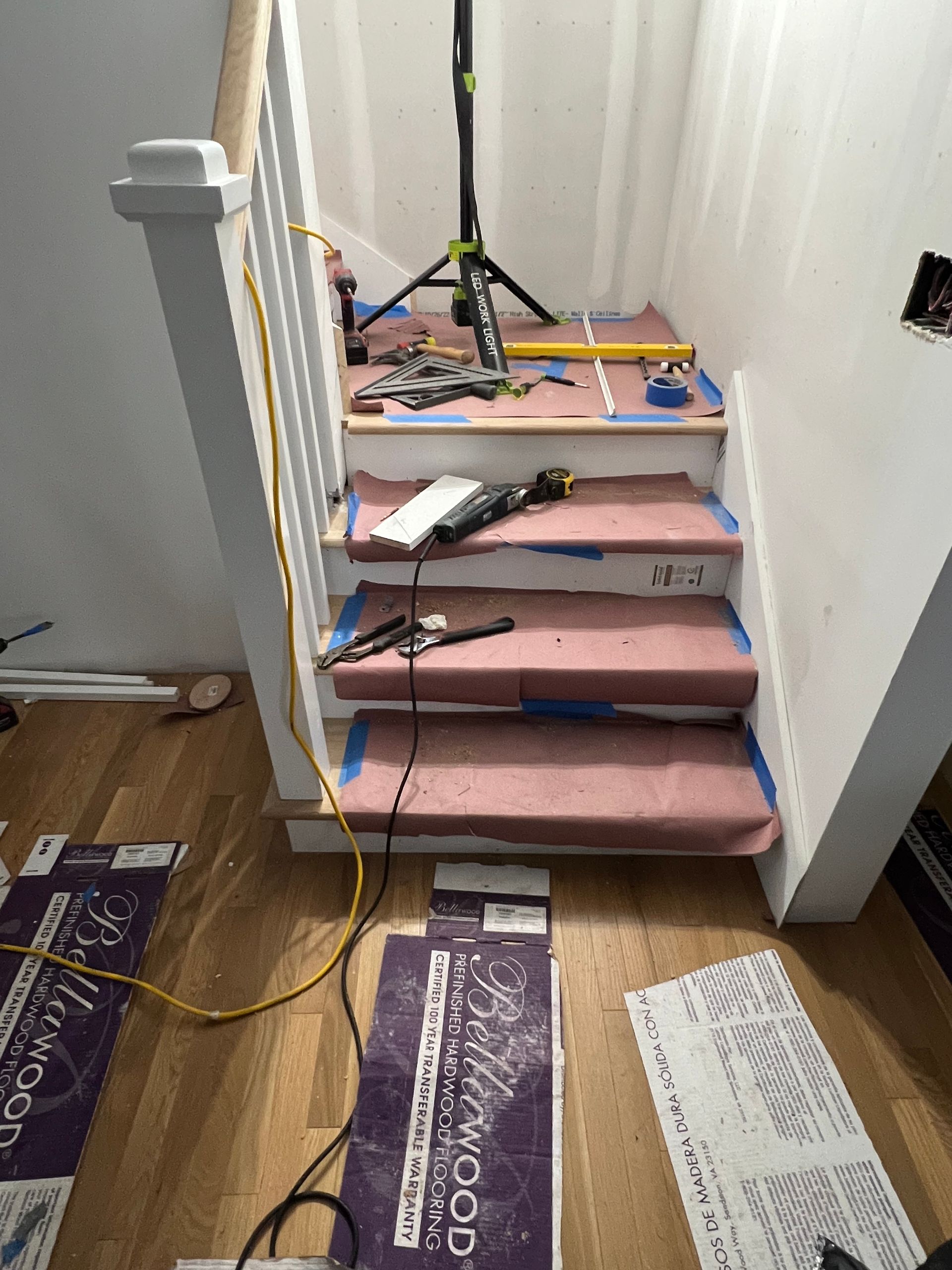 A staircase is being remodeled with a wooden floor.