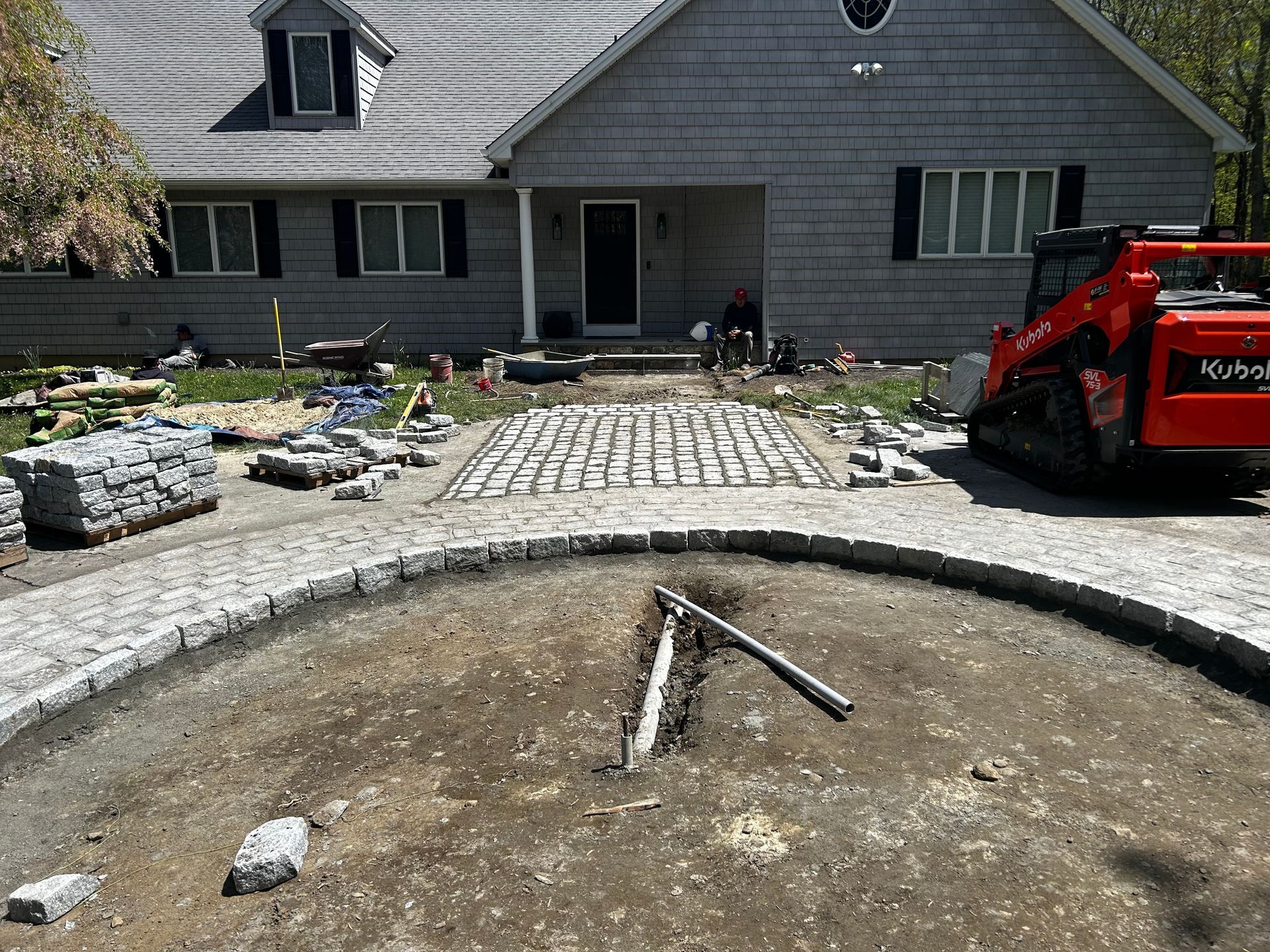A red bulldozer is parked in front of a house.
