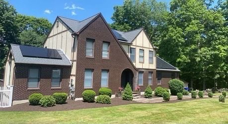A large brick house with solar panels on the roof