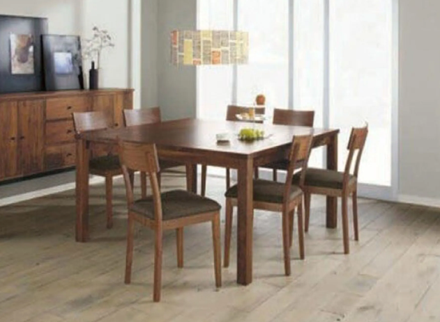 Wooden dining table with six chairs, a sideboard, and a patterned light fixture. Light-colored wooden floors.