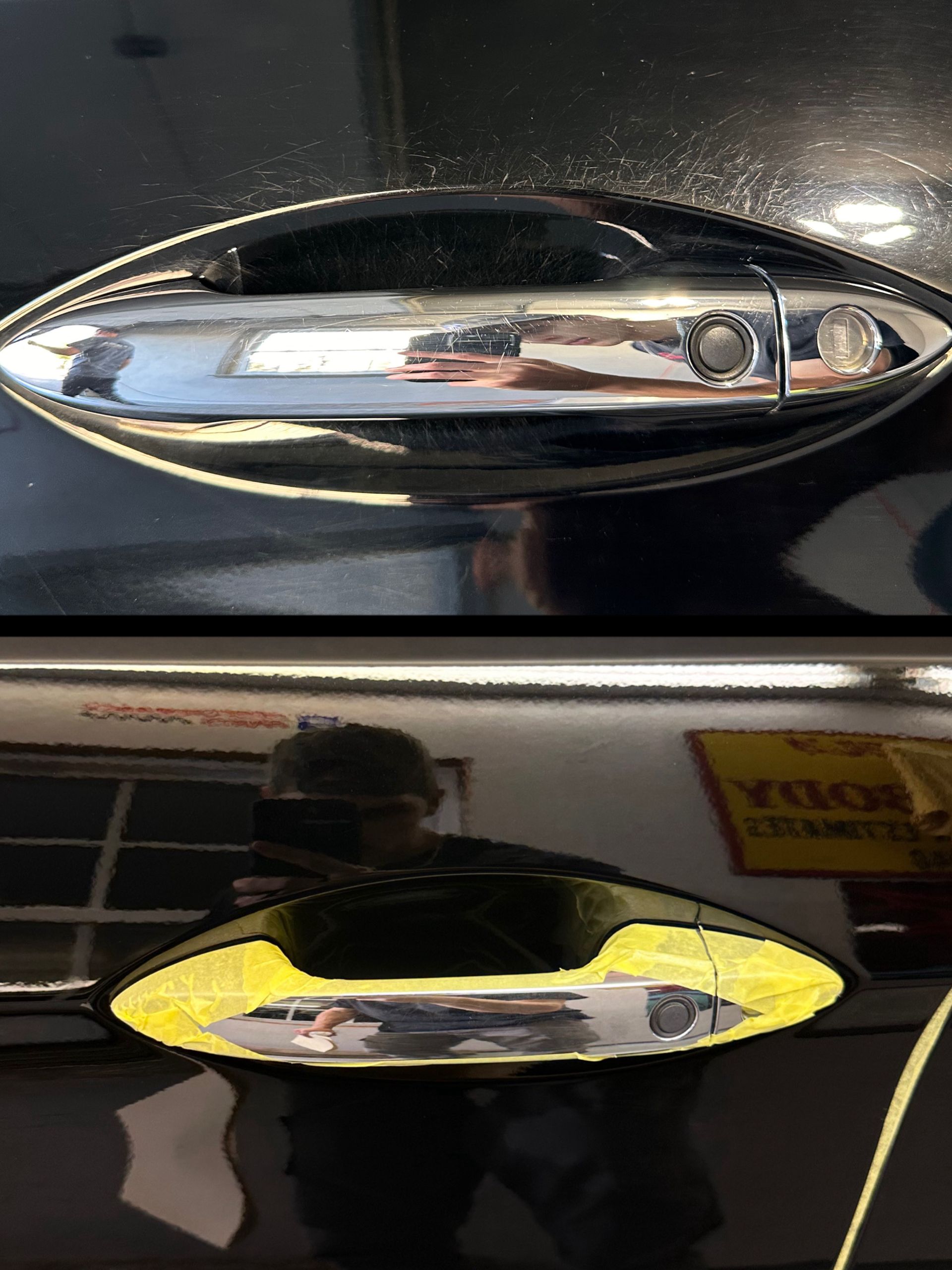Chrome door handle on black car; reflected light highlights the person holding a phone and part of a building.