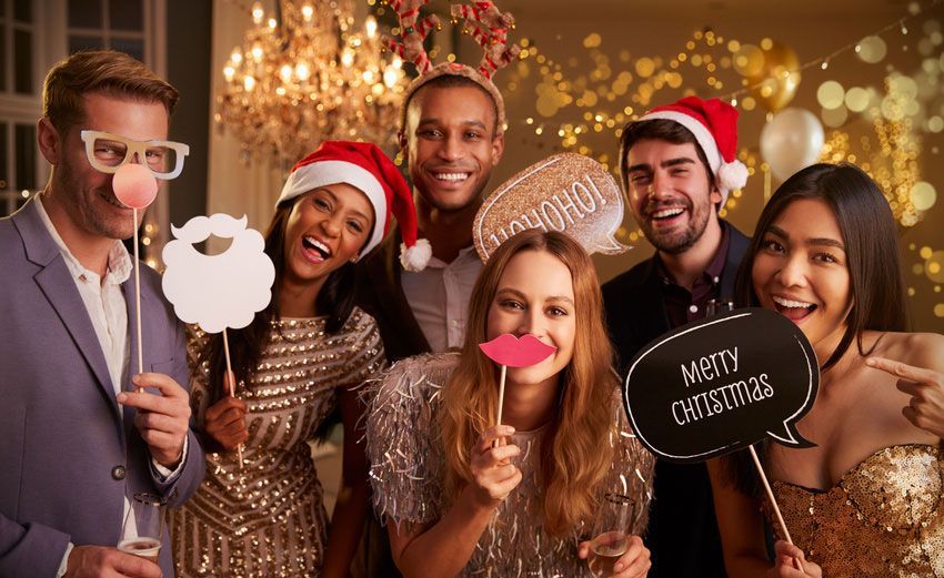 A group of people are posing for a picture at a christmas party.