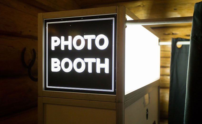 A photo booth is lit up in a dark room