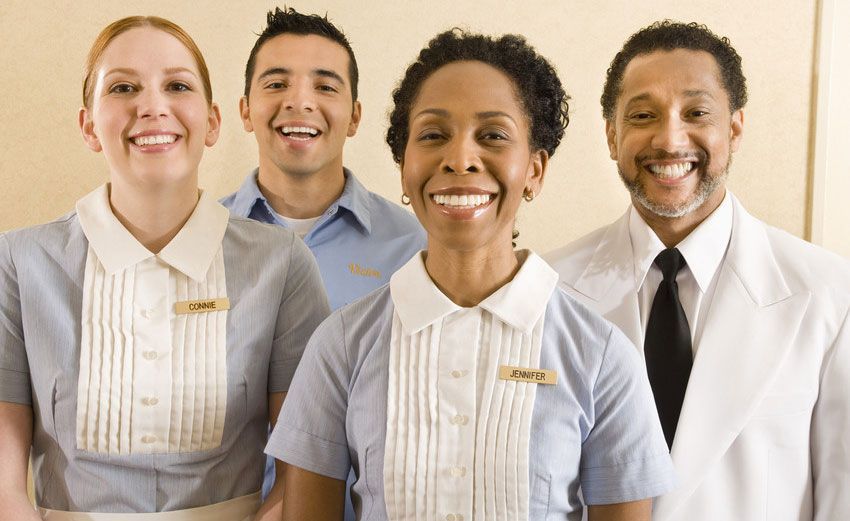 A group of people standing next to each other and smiling