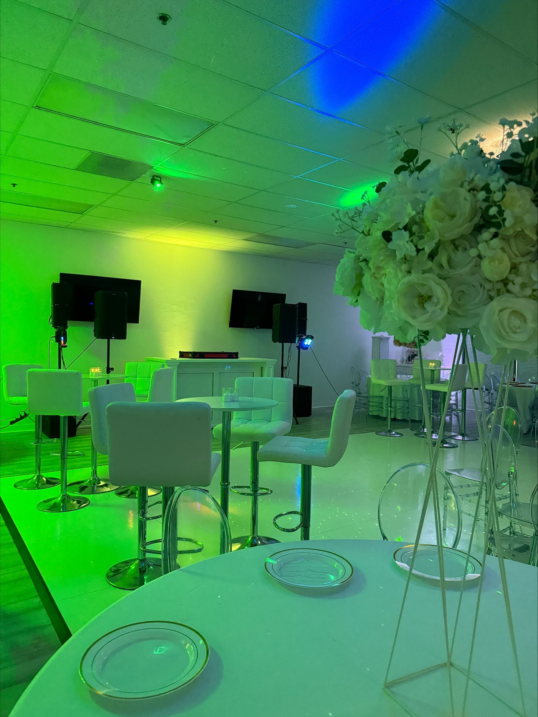 A room filled with tables and chairs and a vase of flowers.