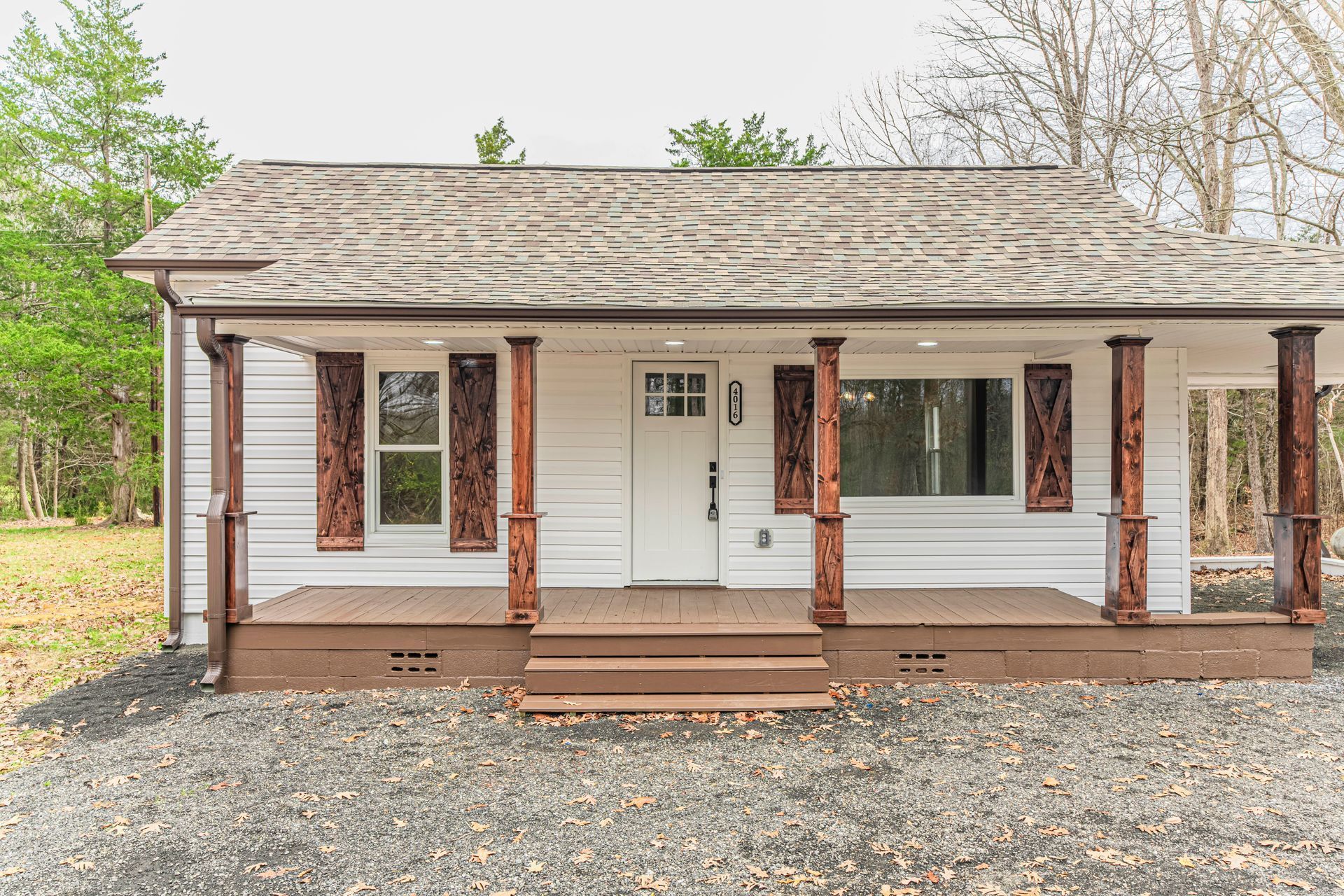 A small white house with a porch and columns