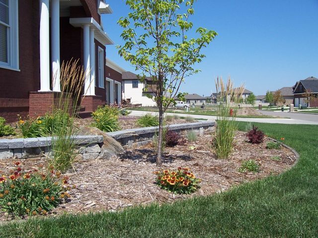 A brick house with a tree in front of it