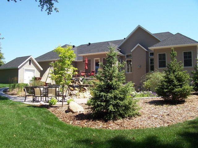 A house with a lot of trees in front of it