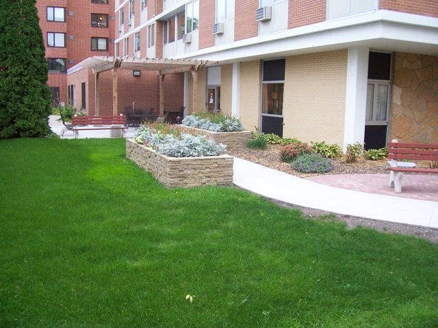 A large building with a lush green lawn in front of it