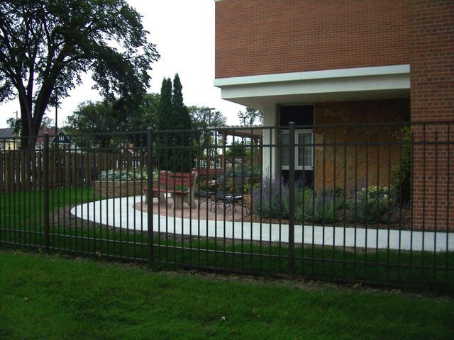A brick building with a fence in front of it