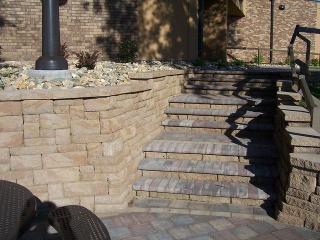 A set of stairs leading up to a brick wall