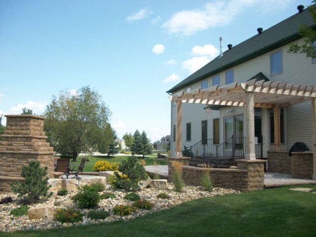 A house with a pergola in front of it