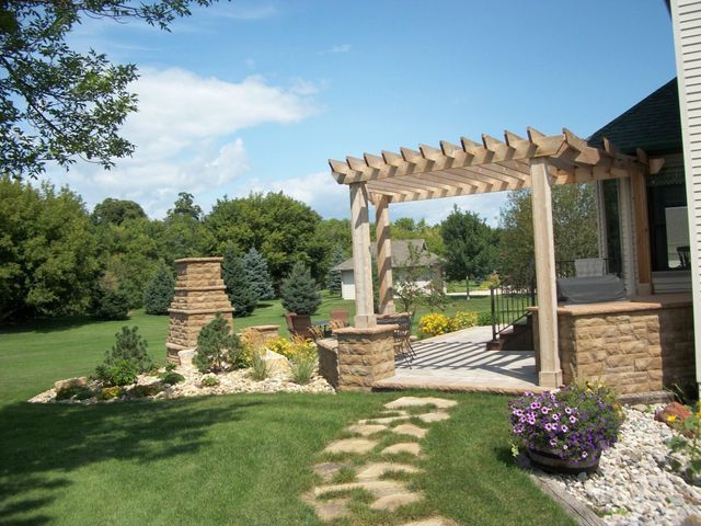 A pergola in the backyard of a house