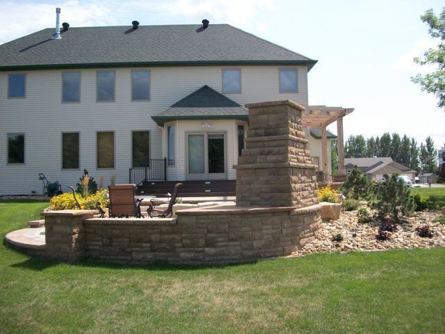 A large house with a fireplace in the backyard