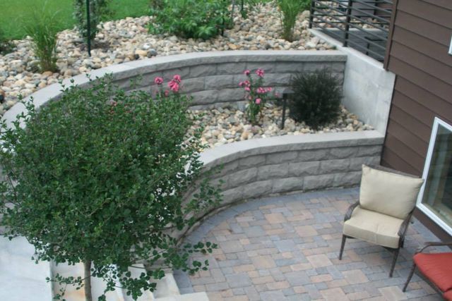 An aerial view of a patio with a chair and a tree