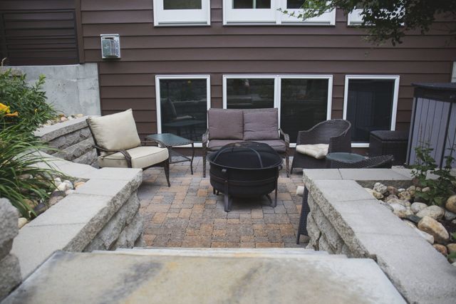 There is a fire pit in the middle of the patio.