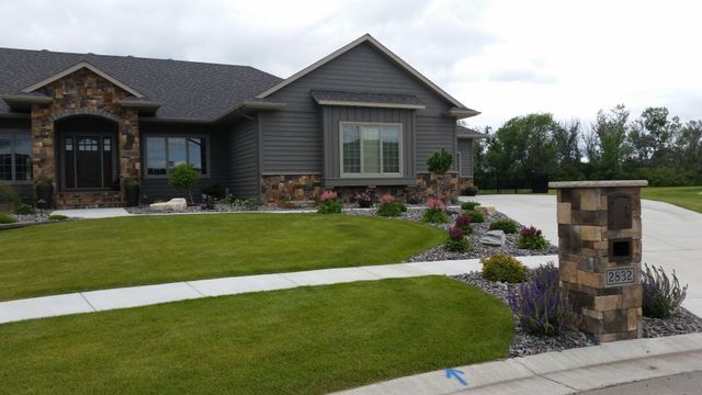 A large house with a lush green lawn in front of it