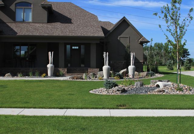 A large house with a lush green lawn in front of it