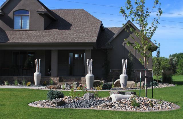 A large house with a lush green lawn in front of it