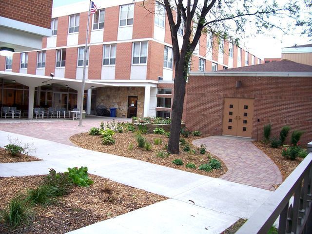 A brick building with a tree in front of it