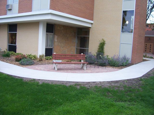 A brick building with a bench in front of it