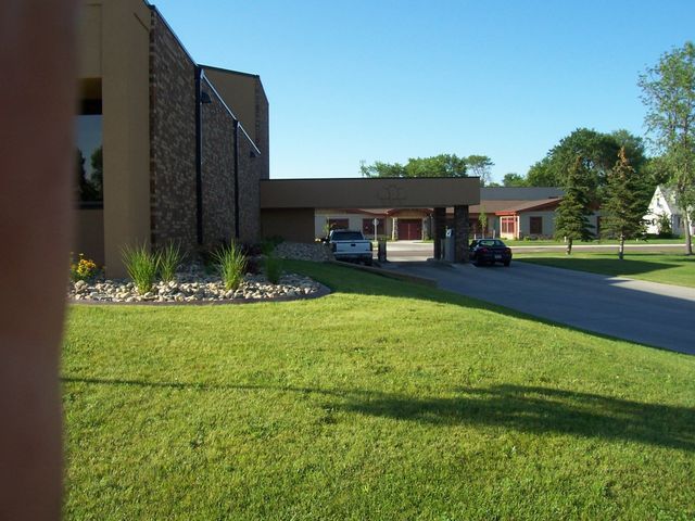 A large building with a car parked in front of it