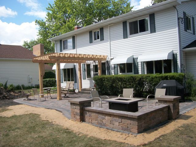A white house with a fire pit in front of it