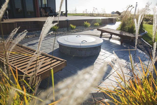 There is a fire pit in the middle of the patio.