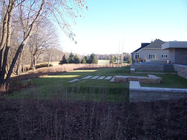 A backyard with a house in the background