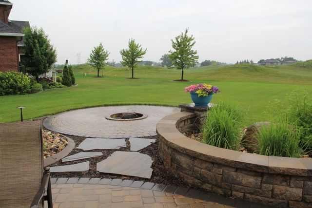 There is a fire pit in the middle of the patio.