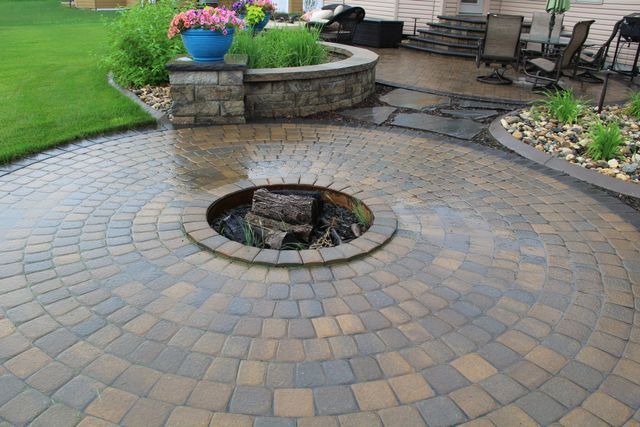 There is a fire pit in the middle of the patio.