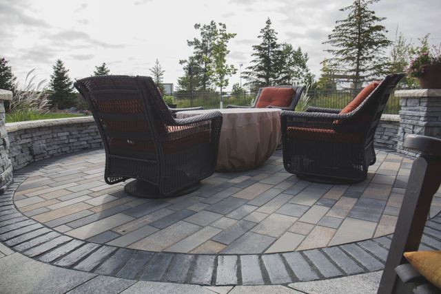 A patio with a table and chairs on it