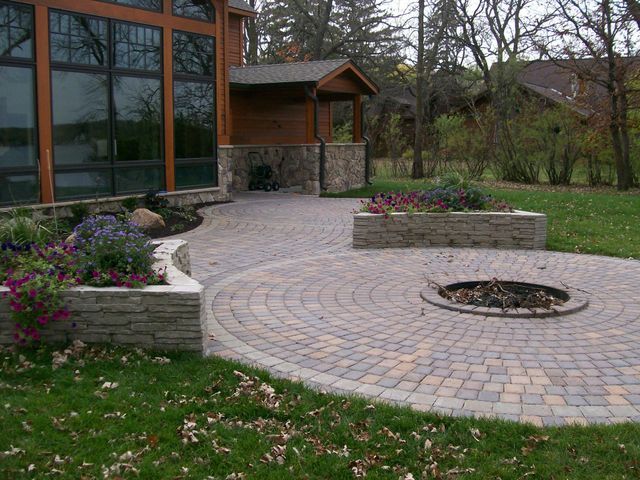 There is a fire pit in the middle of the patio.