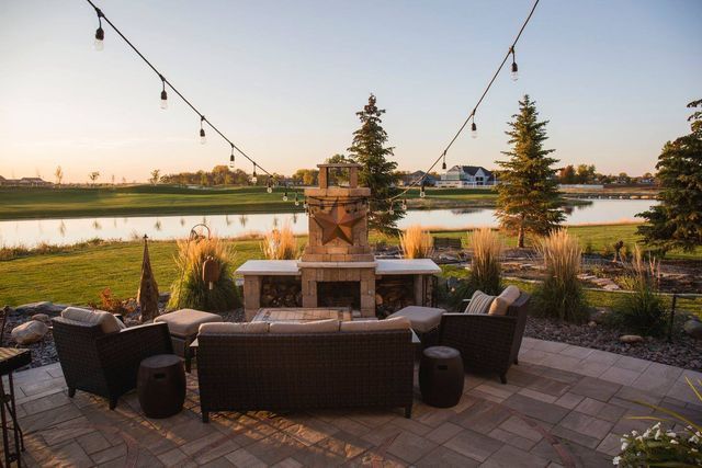 There is a fireplace in the middle of the patio.