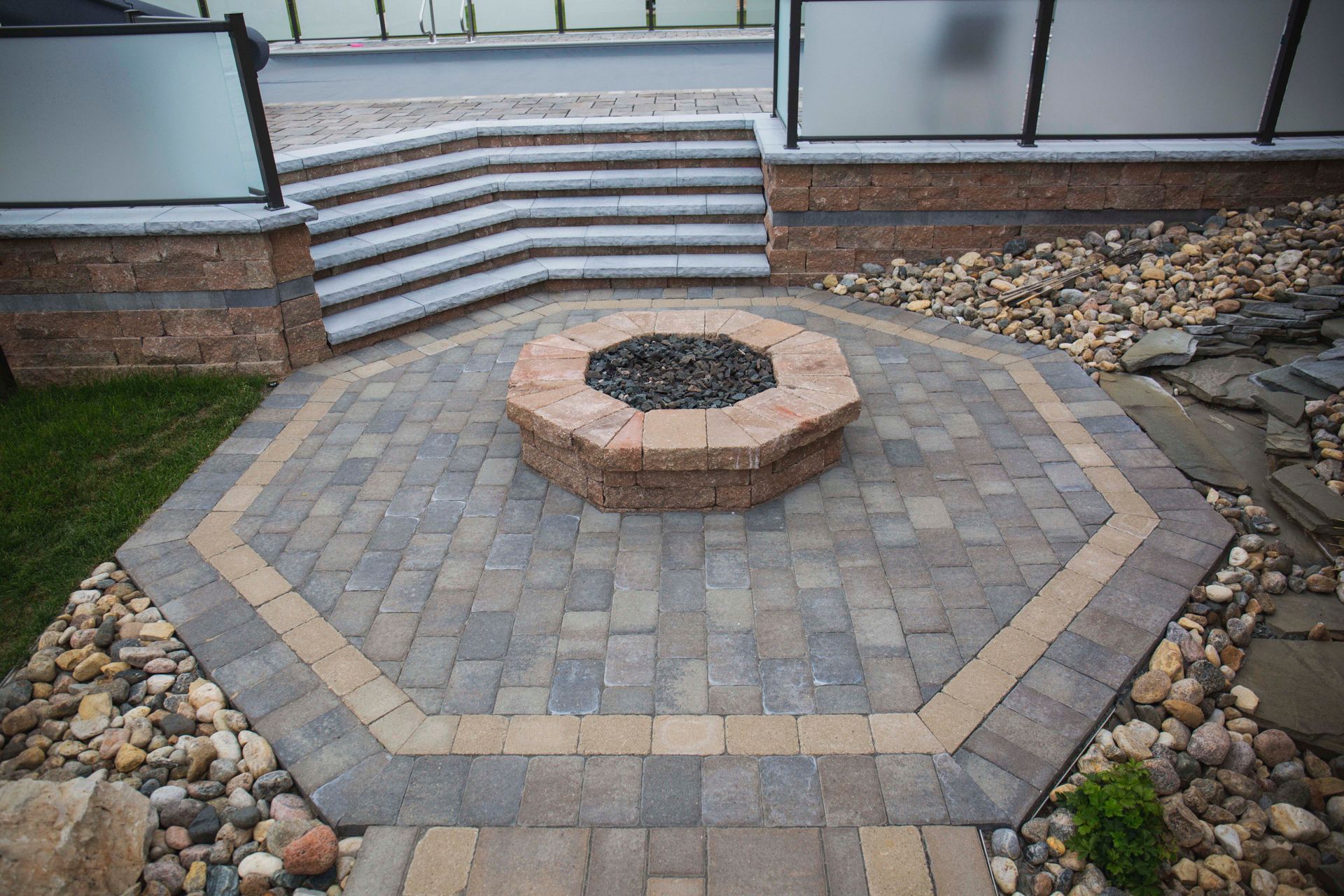 There is a fire pit in the middle of the patio.