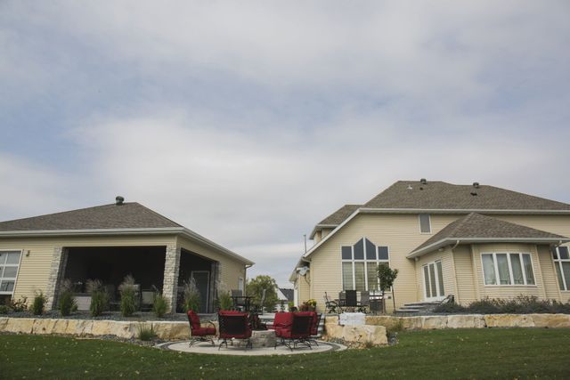 A large house with a patio area in front of it
