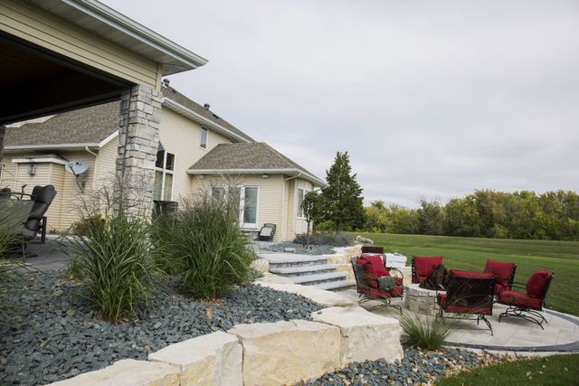 A large house with a patio area in front of it.