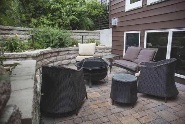 There is a fire pit in the middle of the patio.