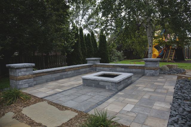 There is a fire pit in the middle of the patio.