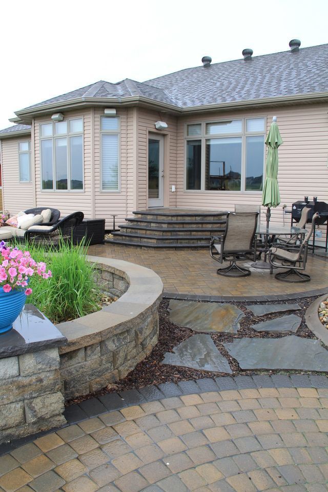 A large house with a patio and stairs in front of it